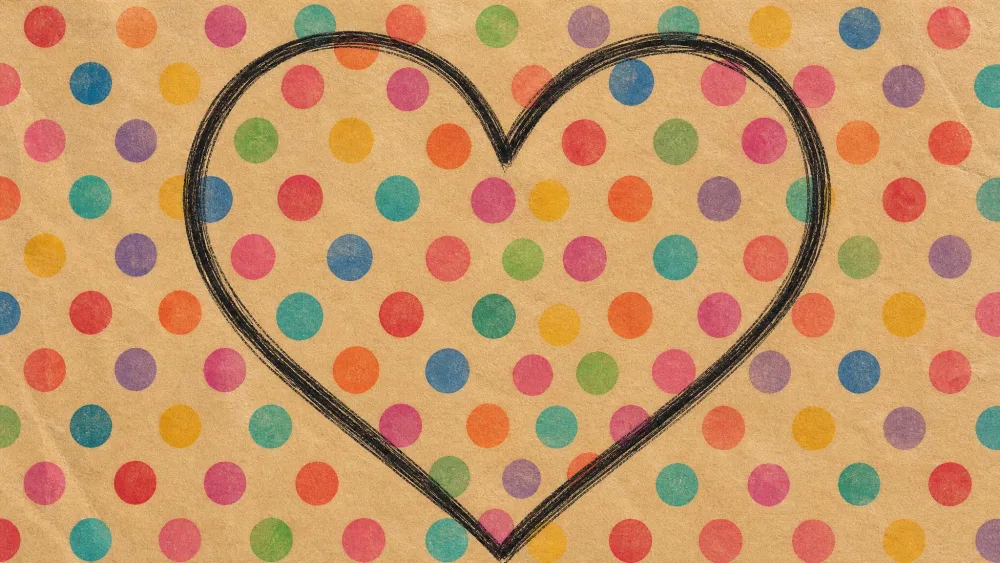 Large heart covered in colorful repeating polka dots, Kusama-style.