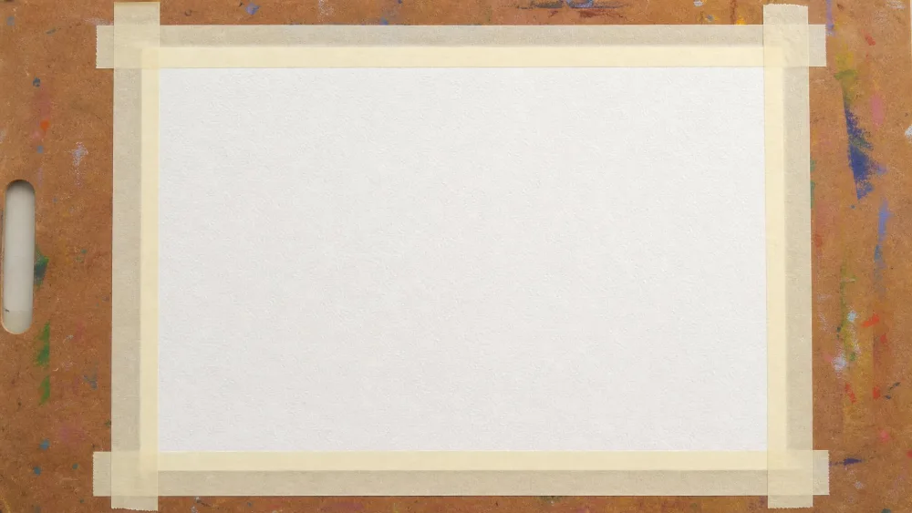 Watercolor paper taped flat to a board along all four edges before a child begins painting