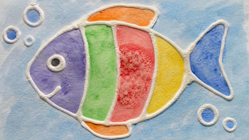 A child's watercolor painting with raised glue-line outlines and table salt sprinkled into the wet paint, showing the salt soaking up color inside one section.