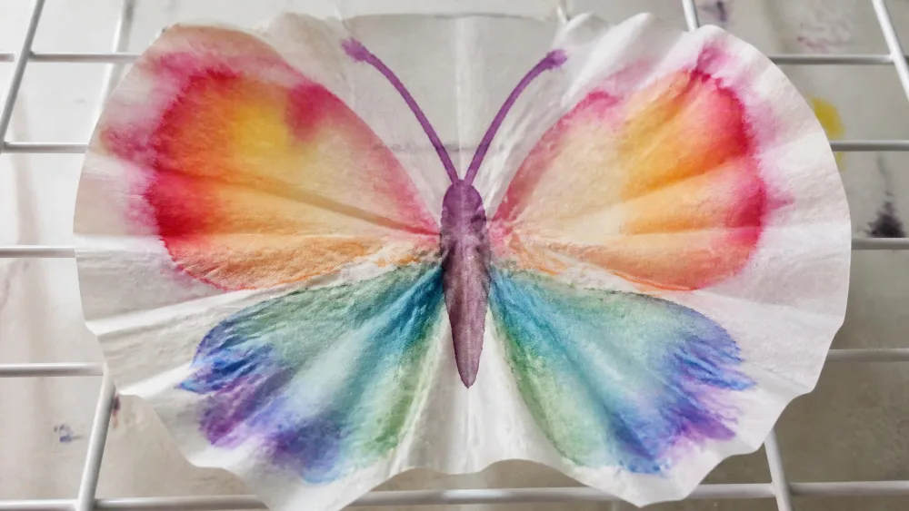 A watercolor coffee filter drying into a butterfly.