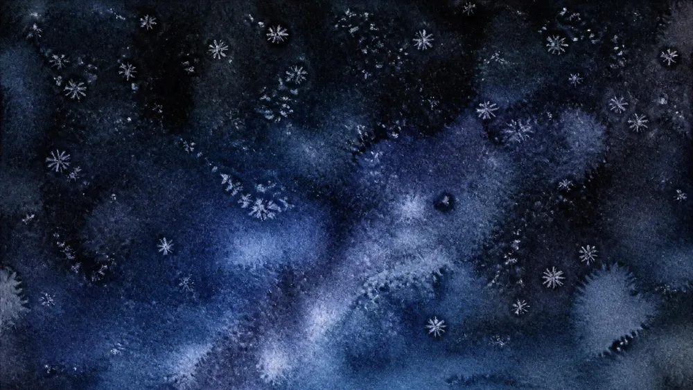 Salt forming starry speckles on a dark watercolor sky.