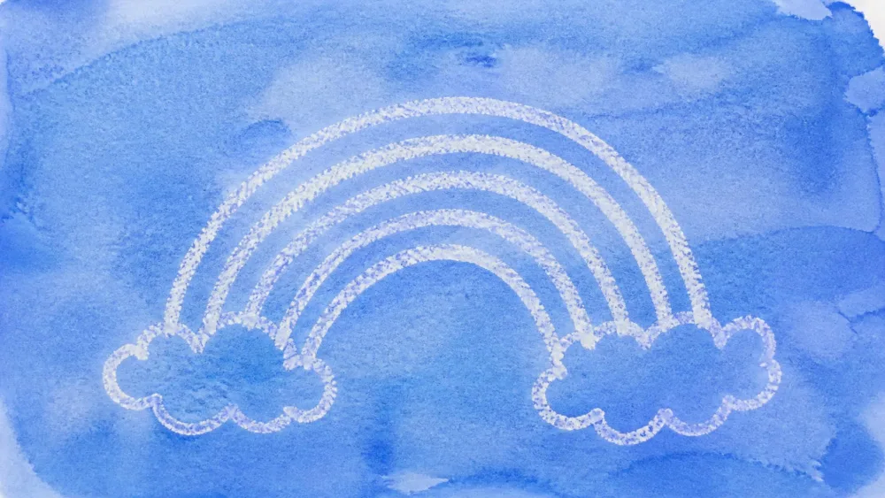White-crayon rainbow appearing under a blue watercolor wash.