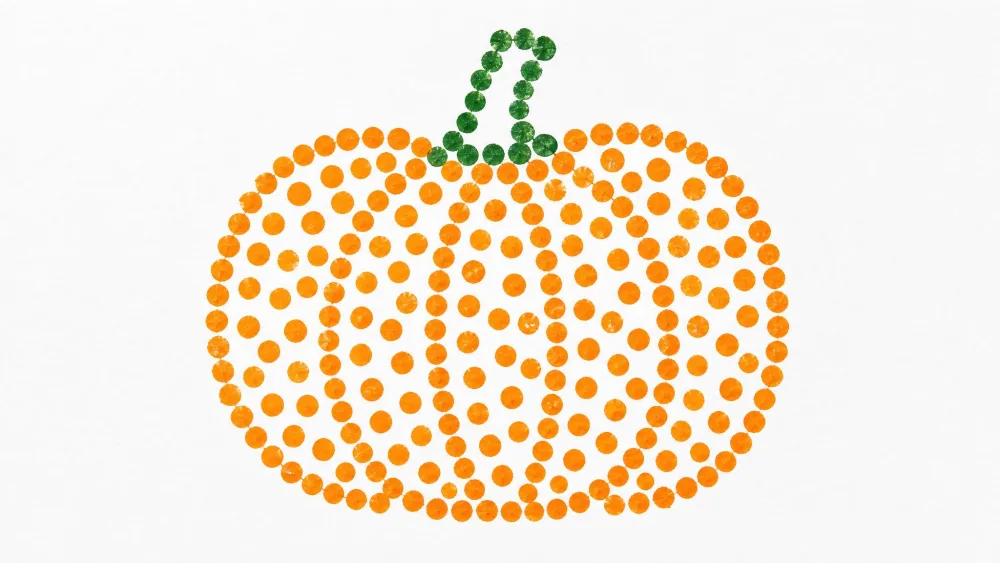 A pumpkin outline filled with orange dots made using a paint-dipped cotton swab.