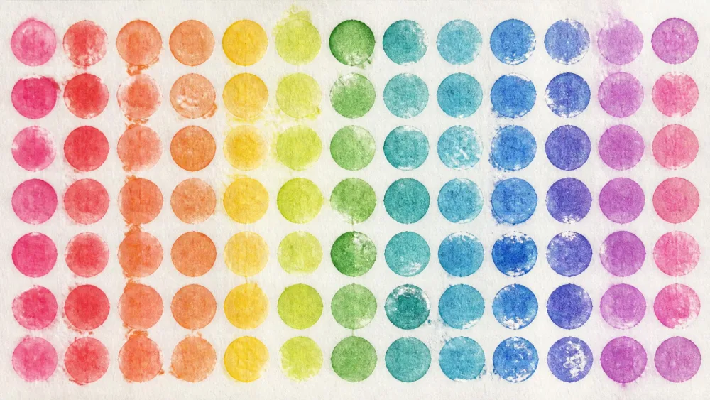 Bubble wrap pressed onto paper making rows of round watercolor dots.