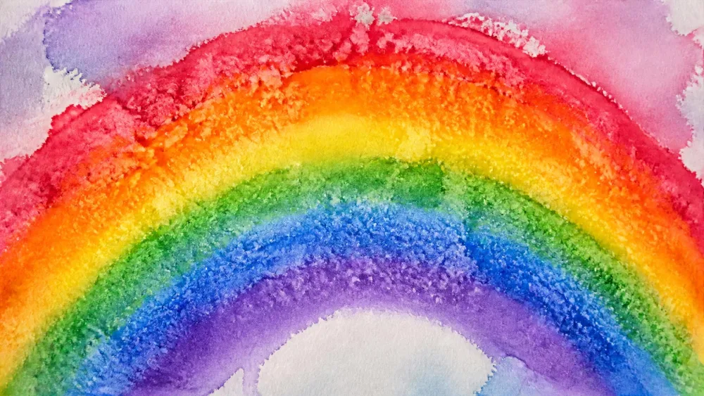 Wet watercolor rainbow with salt creating a speckled texture.
