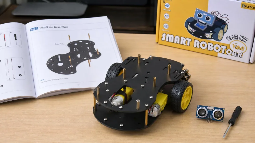 A half-assembled ELEGOO Smart Robot Car Kit V4 chassis on a desk with its ultrasonic sensor module and a small screwdriver beside it, the printed manual open to the base-plate step.